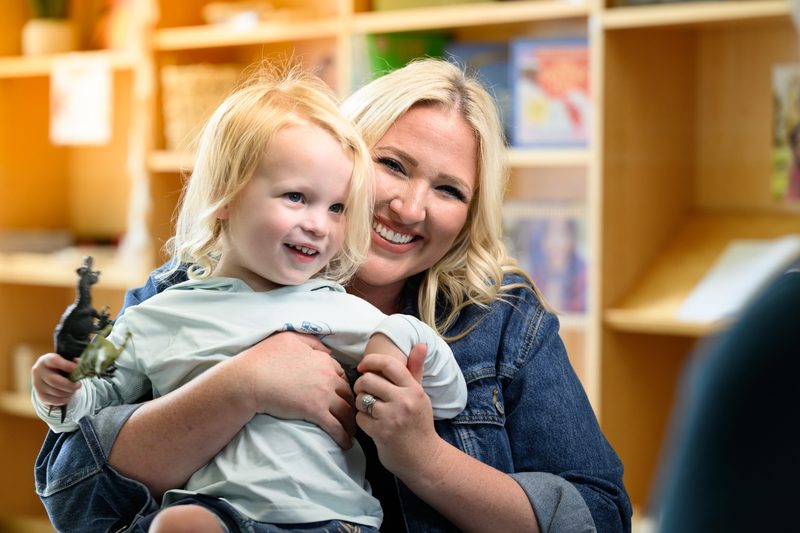 A smiling child and caregiver at Easterseals